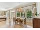 Sunlit dining room with neutral walls, large windows, and views of the private, landscaped backyard at 4012 W Obispo St, Tampa, FL 33629