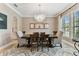 Formal dining room featuring a decorative chandelier, neutral walls, and ample natural light at 4012 W Obispo St, Tampa, FL 33629