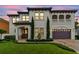 Elegant two-story home with a barrel tile roof, manicured lawn, and an attached two-car garage at 4012 W Obispo St, Tampa, FL 33629