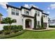Beautiful two-story home featuring manicured landscaping, a barrel tile roof, and a brick paver driveway at 4012 W Obispo St, Tampa, FL 33629