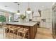 Modern kitchen with white cabinets, stainless steel appliances, a large island, and barstool seating at 4012 W Obispo St, Tampa, FL 33629