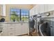 A functional laundry room with sleek appliances, countertops and natural light from the window at 4012 W Obispo St, Tampa, FL 33629