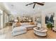 Open-concept living area with a comfortable sofa, ceiling fan, and a view into the modern kitchen at 4012 W Obispo St, Tampa, FL 33629