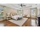 Spacious main bedroom with tray ceiling, an accent wall, hardwood floors, and lots of natural light at 4012 W Obispo St, Tampa, FL 33629