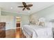 Bright main bedroom with hardwood floors and a glimpse into the bathroom, creating a serene atmosphere at 4012 W Obispo St, Tampa, FL 33629