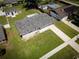 Aerial view of a single-story home, showcasing the lush lawn and spacious driveway at 5018 Pine St, Seffner, FL 33584