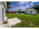 View of large backyard, shed, screen enclosed porch, and fenced yard at 5018 Pine St, Seffner, FL 33584