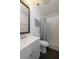 Bright bathroom with a white vanity and sink, toilet, and shower with gray curtain at 5018 Pine St, Seffner, FL 33584