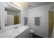 Bright bathroom with a white vanity and sink, toilet, and tiled shower with curtain at 5018 Pine St, Seffner, FL 33584