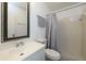 Clean bathroom with a white vanity and sink, toilet, and shower with a curtain at 5018 Pine St, Seffner, FL 33584