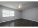 Bright bedroom with large window, ceiling fan, and hardwood floors at 5018 Pine St, Seffner, FL 33584