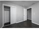 A secondary bedroom with new dark floors, gray paint, and a closet at 5018 Pine St, Seffner, FL 33584