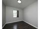 Bedroom showcasing gray paint, neutral light fixture, modern floors, and a window at 5018 Pine St, Seffner, FL 33584