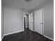 A secondary bedroom with new dark floors, gray paint, and a closet at 5018 Pine St, Seffner, FL 33584