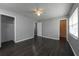 Bright bedroom with hardwood floors, ceiling fan, and neutral walls at 5018 Pine St, Seffner, FL 33584