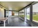 Enclosed back porch featuring tile floors, sliding doors, and views of the backyard at 5018 Pine St, Seffner, FL 33584