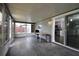 Enclosed back porch featuring tile floors, sliding doors, and views of the backyard at 5018 Pine St, Seffner, FL 33584