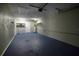This garage features painted floors, a service door and painted block walls at 5018 Pine St, Seffner, FL 33584