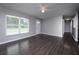 Bright living area showcasing hardwood floors, large windows, and a seamless, open design at 5018 Pine St, Seffner, FL 33584