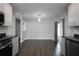 Open floor plan featuring a view from the kitchen to the dining and living areas, with hardwood floors at 5018 Pine St, Seffner, FL 33584