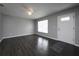 Inviting living room features hardwood floors, ample natural light, and a fresh, neutral color scheme at 5018 Pine St, Seffner, FL 33584