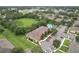Aerial shot of townhomes with a community pool, reserved parking, and surrounded by green spaces at 6332 Timberly Ln, Zephyrhills, FL 33542