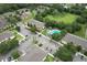 Aerial view of residential community with ample parking, pool, and green space at 6332 Timberly Ln, Zephyrhills, FL 33542