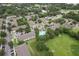 Overhead view of a community with trees, residential buildings, streets, and a pool at 6332 Timberly Ln, Zephyrhills, FL 33542