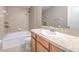Bathroom with tile floors and a shower-tub combo, featuring granite countertops at 6332 Timberly Ln, Zephyrhills, FL 33542