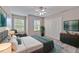 Comfortable bedroom featuring a ceiling fan, natural light, and closet space at 6332 Timberly Ln, Zephyrhills, FL 33542