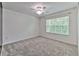 Bright bedroom with a ceiling fan, a window, and carpet at 6332 Timberly Ln, Zephyrhills, FL 33542