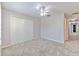 Bright bedroom featuring a ceiling fan, neutral walls, and closet at 6332 Timberly Ln, Zephyrhills, FL 33542