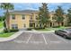 Inviting two-story townhome featuring reserved parking, well-manicured landscaping, and a welcoming entrance at 6332 Timberly Ln, Zephyrhills, FL 33542