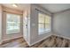 Welcoming foyer featuring wood-look flooring, a bright window, and a classic front door at 6332 Timberly Ln, Zephyrhills, FL 33542