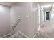 Hallway with carpet floors leading to various rooms and the stairwell at 6332 Timberly Ln, Zephyrhills, FL 33542