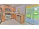 Kitchen with granite countertops and stainless steel appliances, with access to a screened-in patio at 6332 Timberly Ln, Zephyrhills, FL 33542