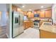 Kitchen with granite countertops, tile floors, and stainless steel appliances at 6332 Timberly Ln, Zephyrhills, FL 33542