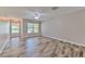Spacious living room with wood-look flooring and ample natural light from large windows at 6332 Timberly Ln, Zephyrhills, FL 33542