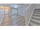 Inviting living room featuring wood-look floors, staircase and abundant natural light at 6332 Timberly Ln, Zephyrhills, FL 33542