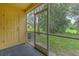 Screened-in back porch with door to the yard at 6332 Timberly Ln, Zephyrhills, FL 33542