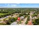 Aerial view of a charming neighborhood showcasing tree-lined streets and well-maintained homes with lush landscaping at 8402 Roxboro Dr, Hudson, FL 34667