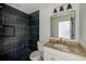 Stylish bathroom featuring black tile shower at 8402 Roxboro Dr, Hudson, FL 34667