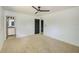 Spacious bedroom featuring neutral carpet and a modern ceiling fan at 8402 Roxboro Dr, Hudson, FL 34667