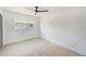 Bright bedroom featuring neutral carpet and a large window at 8402 Roxboro Dr, Hudson, FL 34667