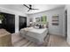 Serene bedroom showcasing a comfortable bed, soft rug, black closets, and decor at 8402 Roxboro Dr, Hudson, FL 34667