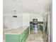 Bright kitchen boasting white cabinets, green lower cabinets, stainless steel appliances, and a spacious island at 8402 Roxboro Dr, Hudson, FL 34667