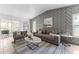 Stylishly furnished living room with modern decor, a decorative wall, and ample natural light at 8402 Roxboro Dr, Hudson, FL 34667