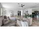 Stylish living room showcasing modern furniture, tile floors, and an open layout to the kitchen at 8402 Roxboro Dr, Hudson, FL 34667