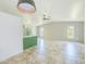 Open-concept living space featuring neutral tile floors and a decorative accent wall with natural lighting at 8402 Roxboro Dr, Hudson, FL 34667