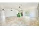 Spacious open-concept living area with tile flooring, a slider, and modern lighting at 8402 Roxboro Dr, Hudson, FL 34667